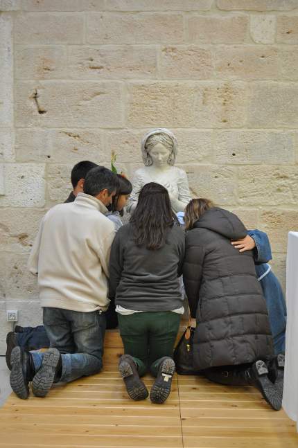 Iesu Communio. Monja y familia rezando junto a la virgen del convento de La Aguilera